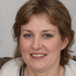 Joyful white adult female with medium  brown hair and blue eyes