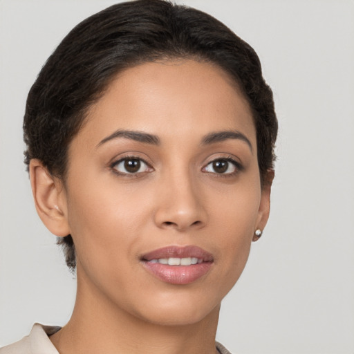 Joyful latino young-adult female with short  brown hair and brown eyes