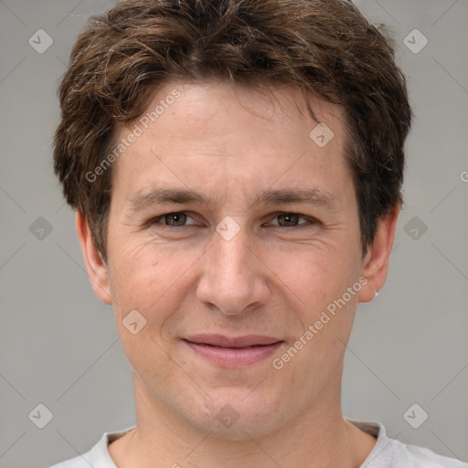 Joyful white adult male with short  brown hair and brown eyes