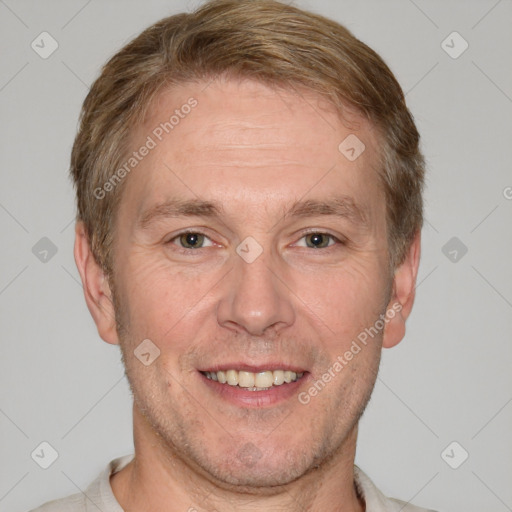 Joyful white adult male with short  brown hair and grey eyes