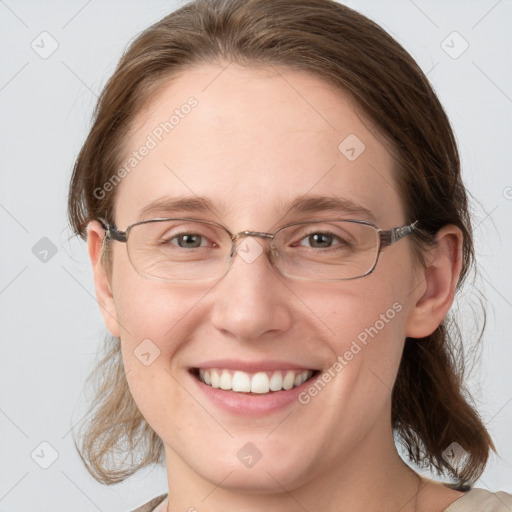 Joyful white adult female with medium  brown hair and blue eyes