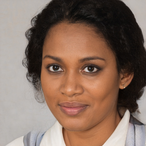 Joyful black young-adult female with medium  brown hair and brown eyes
