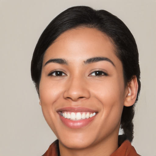 Joyful latino young-adult female with medium  black hair and brown eyes