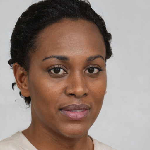 Joyful black young-adult female with short  brown hair and brown eyes