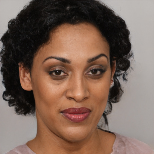 Joyful latino adult female with short  brown hair and brown eyes