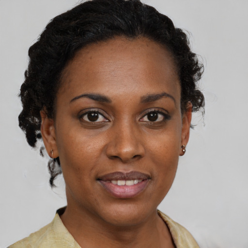 Joyful black young-adult female with medium  brown hair and brown eyes