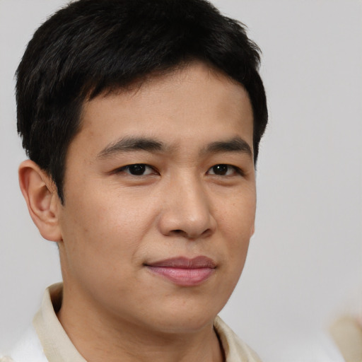 Joyful asian young-adult male with short  brown hair and brown eyes