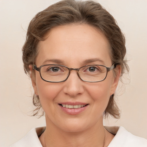 Joyful white adult female with medium  brown hair and grey eyes