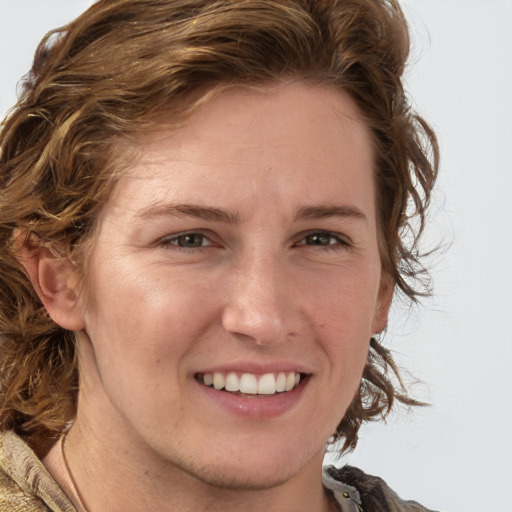 Joyful white young-adult female with medium  brown hair and blue eyes