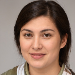 Joyful white young-adult female with medium  brown hair and brown eyes