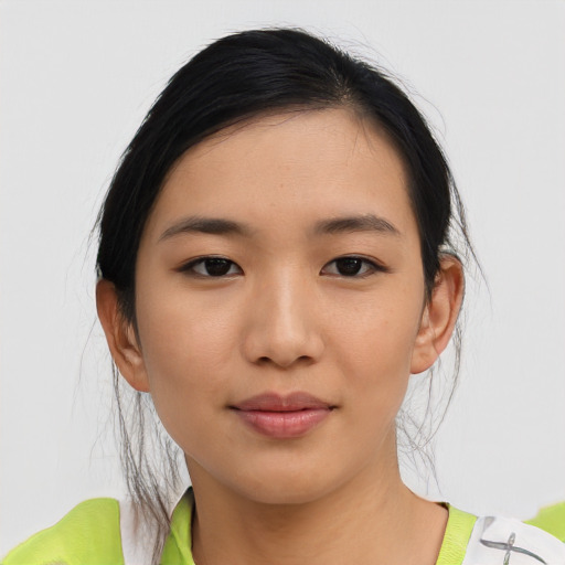 Joyful asian young-adult female with medium  black hair and brown eyes
