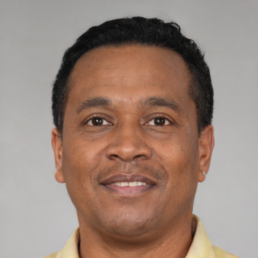 Joyful latino adult male with short  black hair and brown eyes
