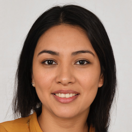 Joyful latino young-adult female with long  brown hair and brown eyes