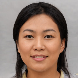 Joyful asian young-adult female with medium  brown hair and brown eyes