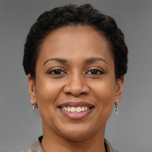 Joyful black adult female with short  brown hair and brown eyes