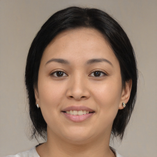 Joyful asian young-adult female with medium  brown hair and brown eyes