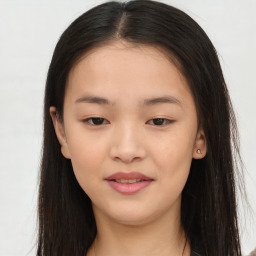 Joyful asian young-adult female with long  brown hair and brown eyes