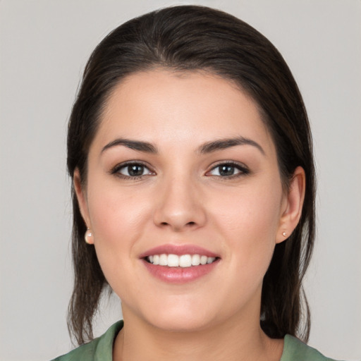 Joyful white young-adult female with medium  brown hair and brown eyes