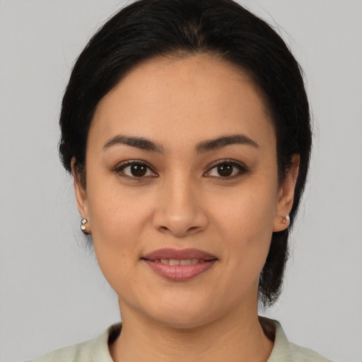 Joyful latino young-adult female with medium  black hair and brown eyes