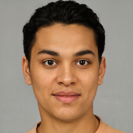 Joyful latino young-adult male with short  black hair and brown eyes