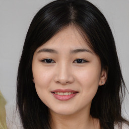 Joyful asian young-adult female with long  brown hair and brown eyes