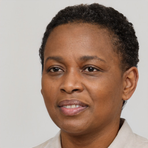 Joyful black adult female with short  brown hair and brown eyes