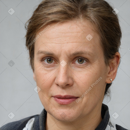 Joyful white adult female with medium  brown hair and brown eyes