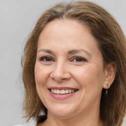 Joyful white adult female with medium  brown hair and brown eyes