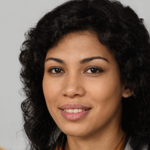 Joyful latino young-adult female with long  black hair and brown eyes