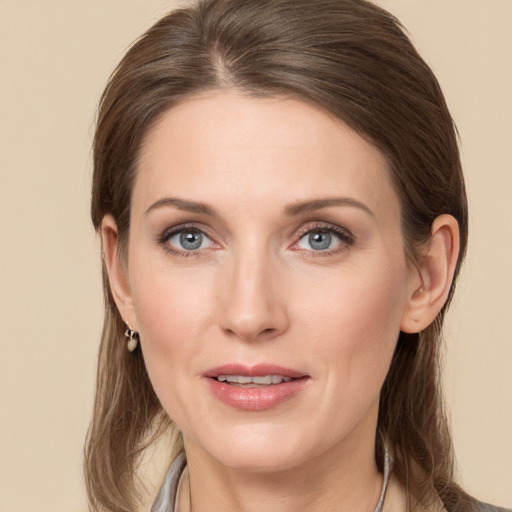 Joyful white young-adult female with medium  brown hair and grey eyes