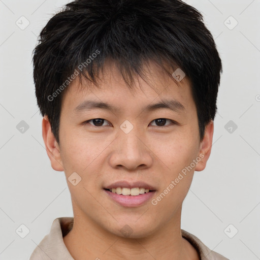 Joyful asian young-adult male with short  brown hair and brown eyes