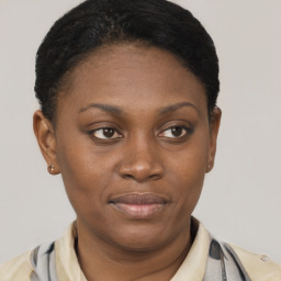 Joyful black young-adult female with short  brown hair and brown eyes