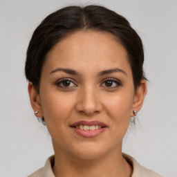 Joyful white young-adult female with medium  brown hair and brown eyes