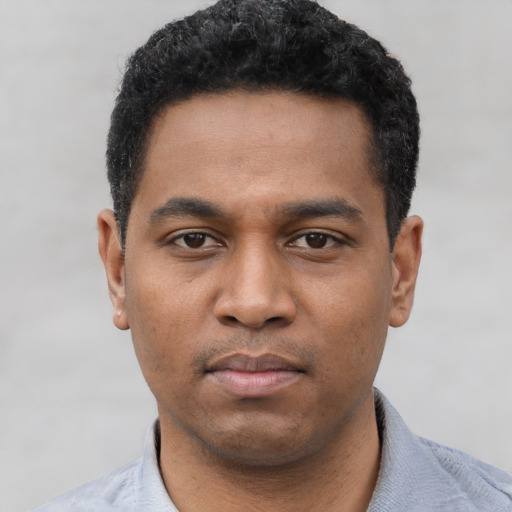 Neutral black young-adult male with short  black hair and brown eyes