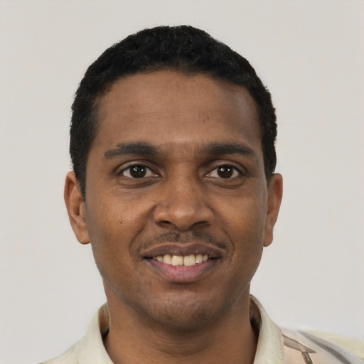 Joyful black young-adult male with short  black hair and brown eyes