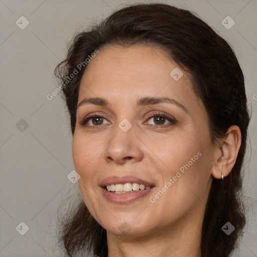 Joyful white adult female with long  brown hair and brown eyes