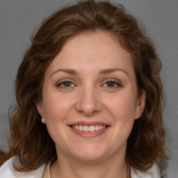 Joyful white adult female with medium  brown hair and grey eyes