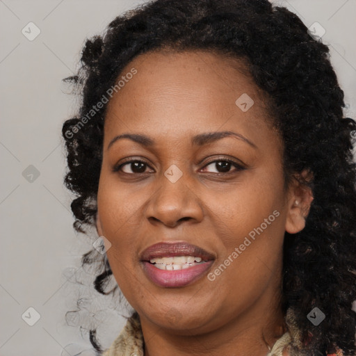 Joyful black adult female with long  brown hair and brown eyes