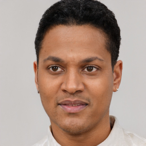 Joyful latino young-adult male with short  black hair and brown eyes