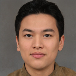 Joyful asian young-adult male with short  brown hair and brown eyes