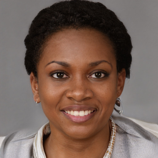 Joyful black young-adult female with short  brown hair and brown eyes