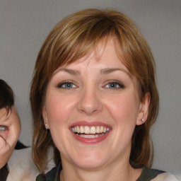 Joyful white young-adult female with medium  brown hair and blue eyes