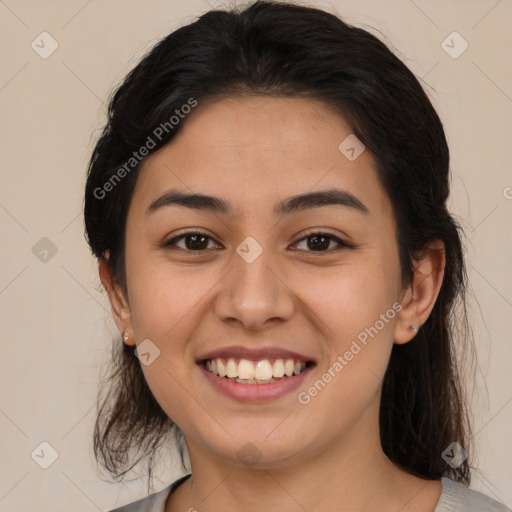 Joyful latino young-adult female with medium  brown hair and brown eyes