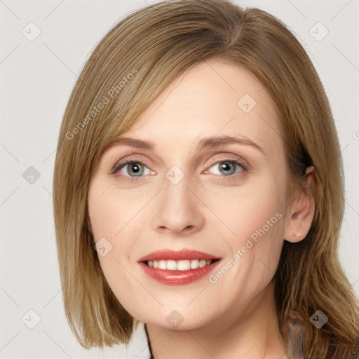 Joyful white young-adult female with medium  brown hair and blue eyes