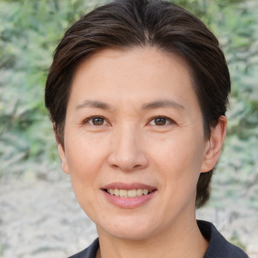 Joyful white adult female with short  brown hair and brown eyes