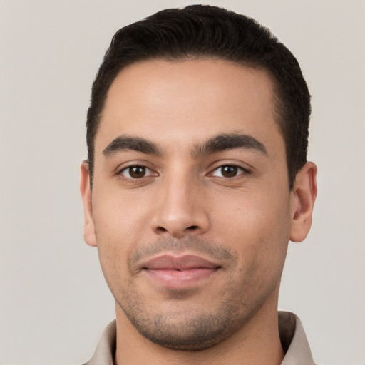 Joyful white young-adult male with short  black hair and brown eyes