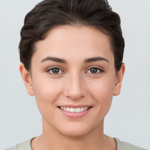 Joyful white young-adult female with short  brown hair and brown eyes