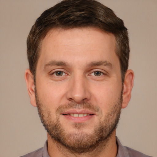 Joyful white young-adult male with short  brown hair and brown eyes