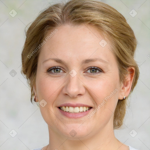 Joyful white adult female with medium  brown hair and green eyes