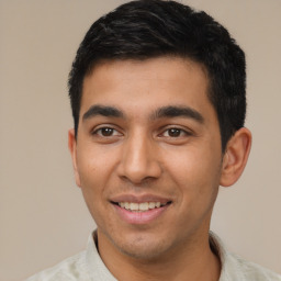 Joyful latino young-adult male with short  black hair and brown eyes